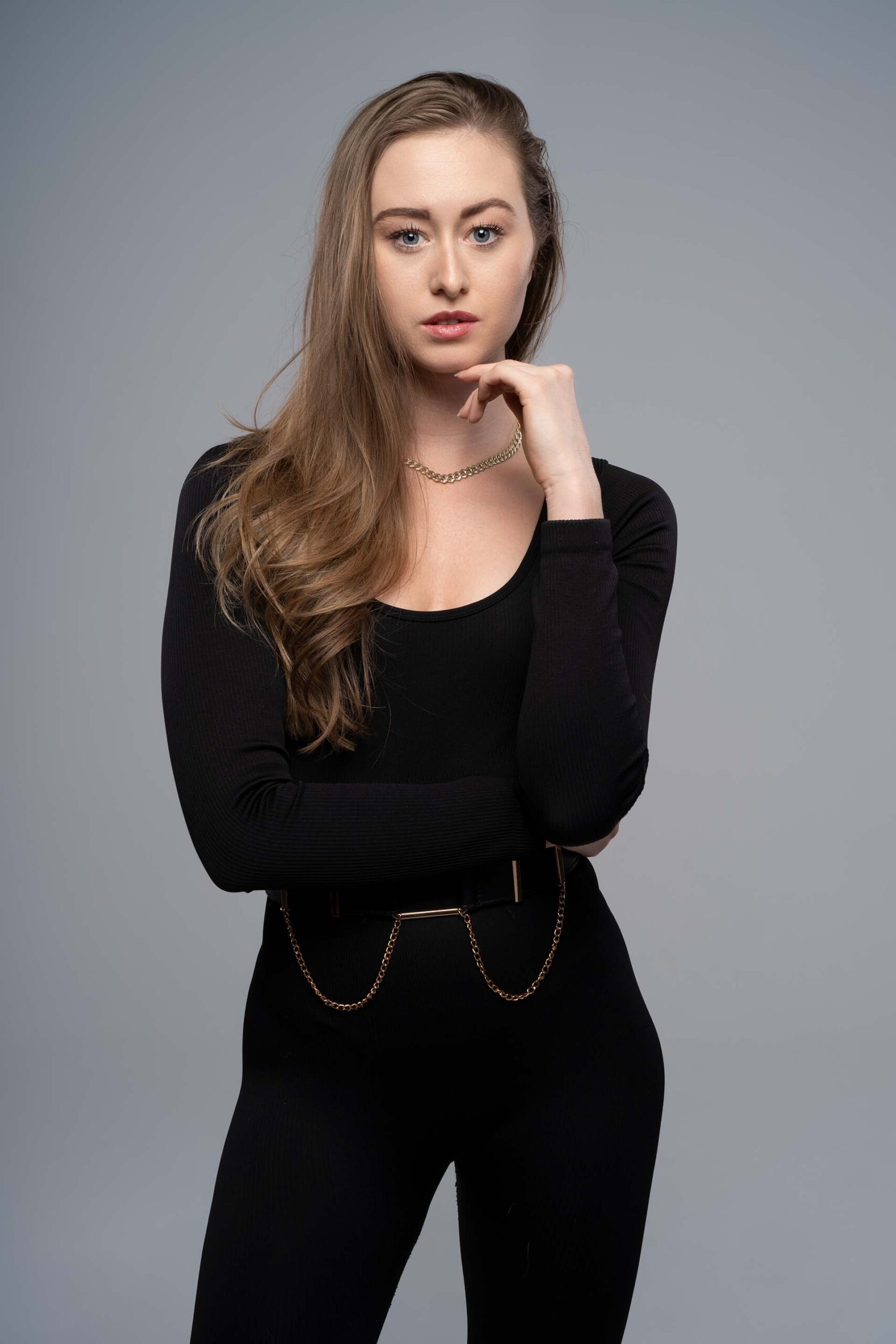 Model in a black bodysuit and boots with hair captured in dynamic motion