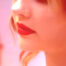 Artistic close-up beauty shot with motion blur and bold red lipstick, pink and red tones