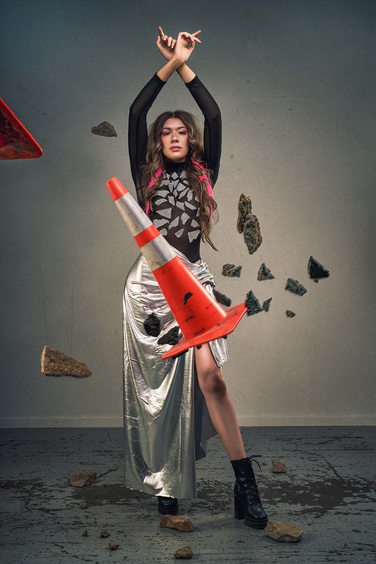 Model in a metallic patterned dress standing against a beige studio backdrop