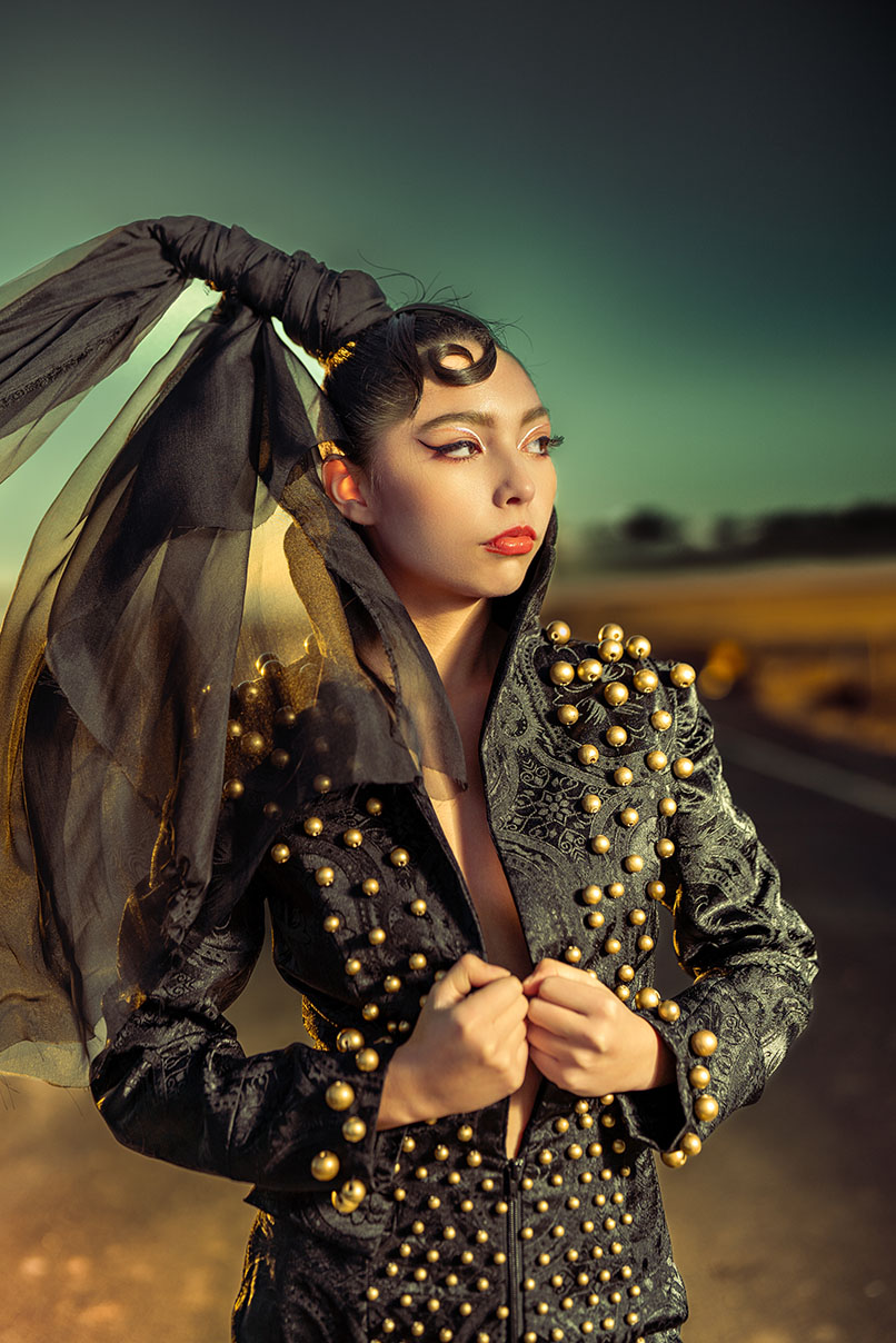 Studded Veil Editorial Photography 04 Close portrait of a model in a gold-studded black jacket with a flowing veil