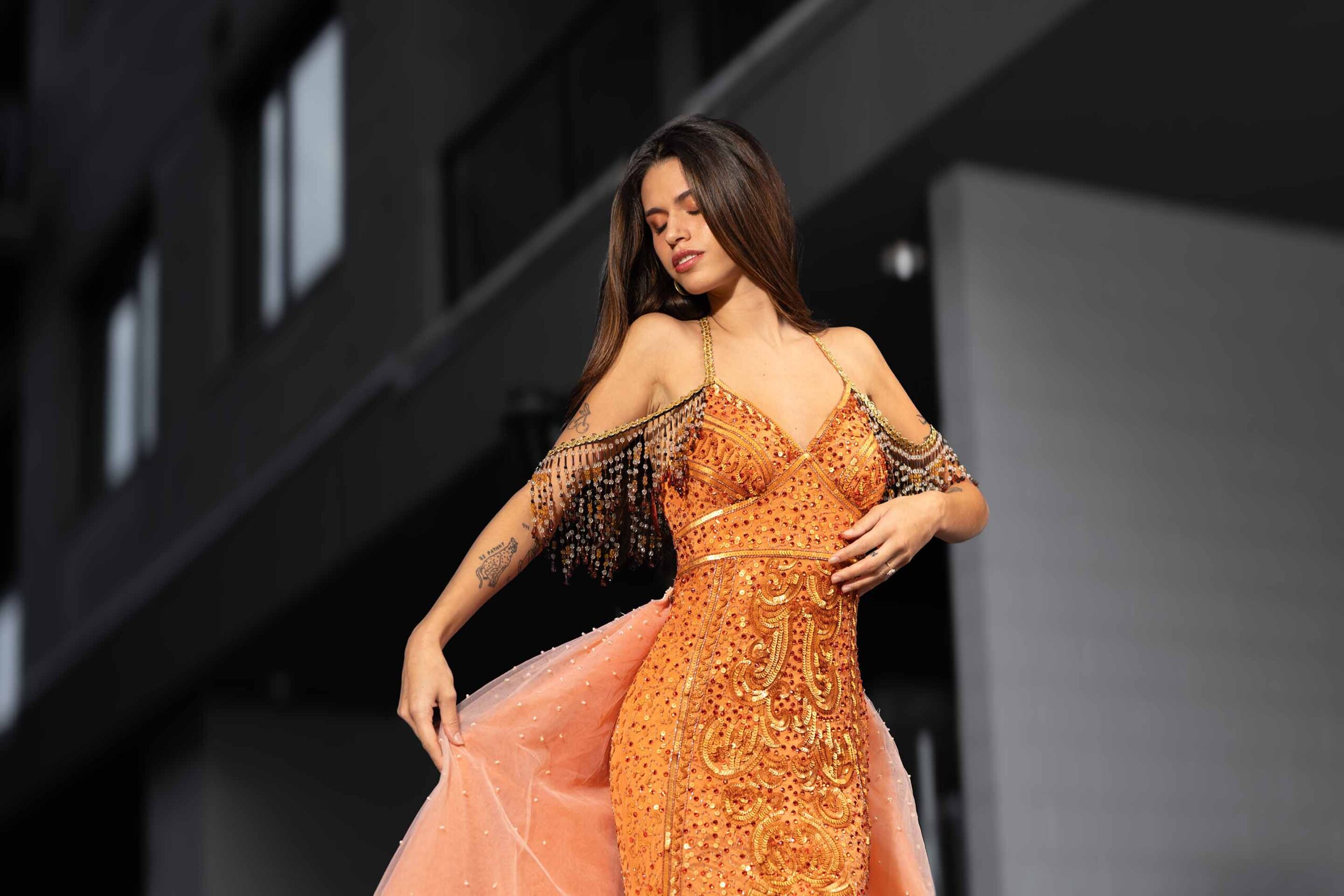 Adi Editorial Fashion Photography 07 Model in an orange gown posing in an alleyway.
