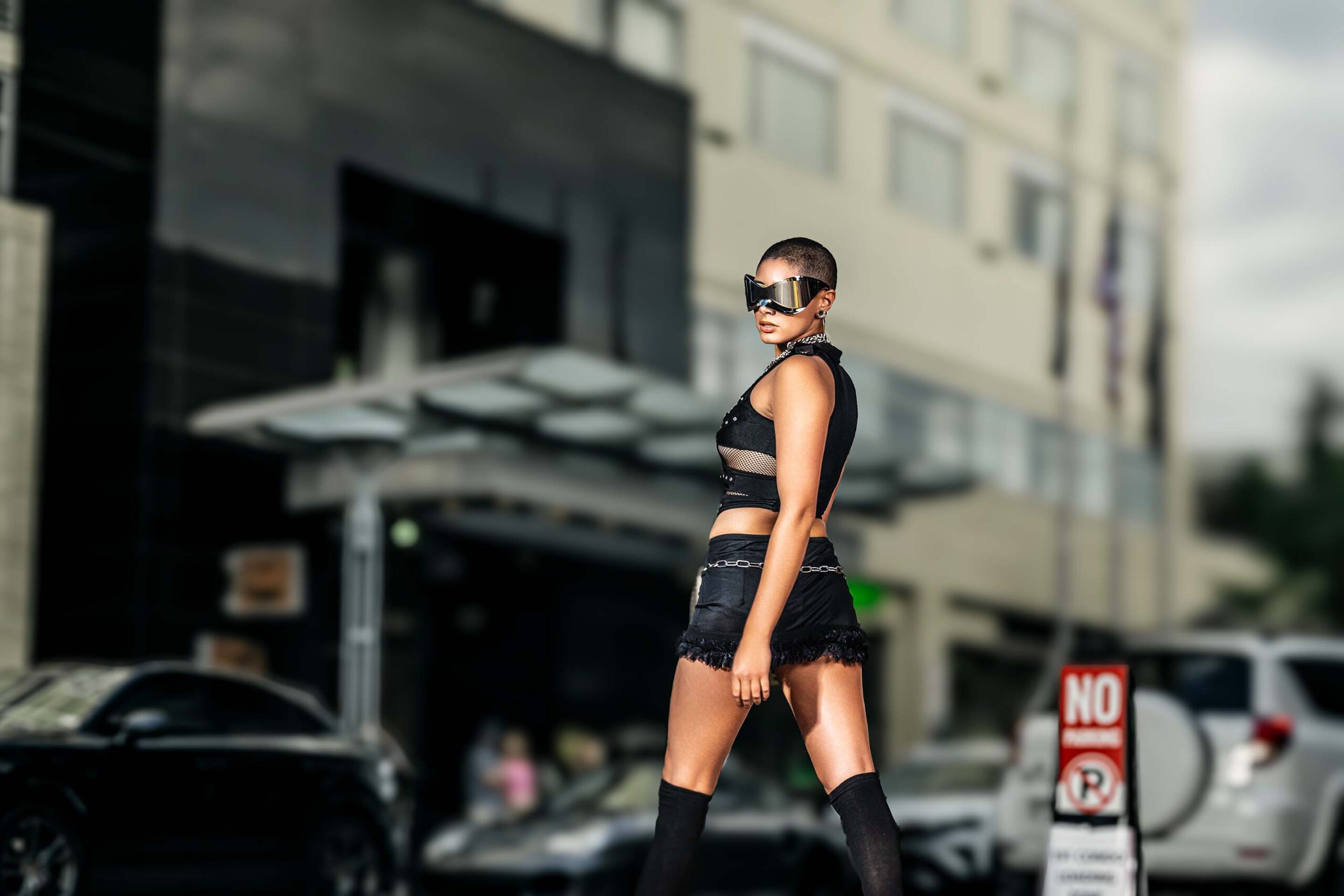 Model in street fashion styling standing on an urban city sidewalk