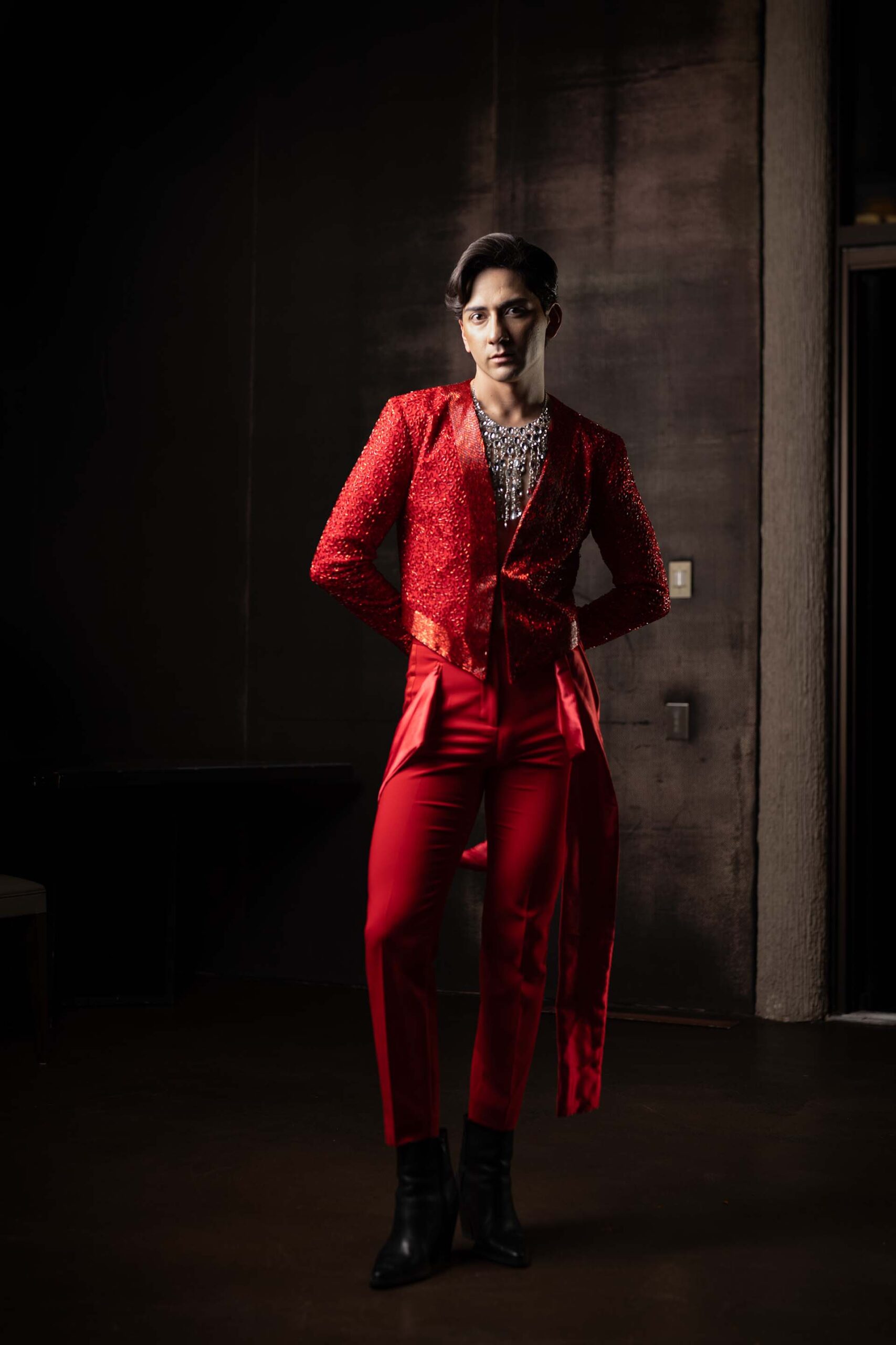 Male model in a tailored red suit posing at the Cableland Venue, formal portrait