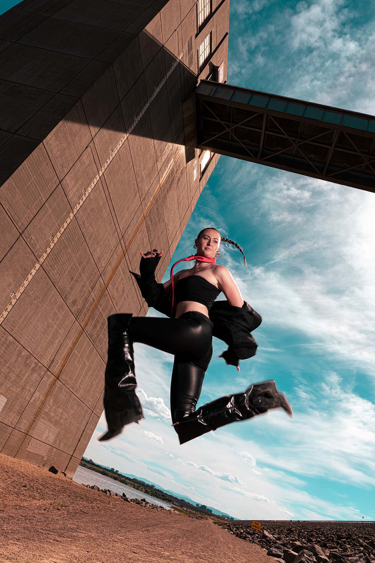 Ashlee mid-jump against the dam structure, alternate angle, Cherry Creek Reservoir