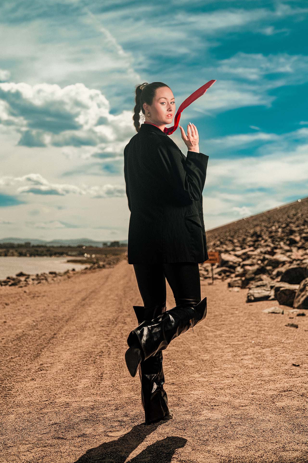 Ashlee in a black blazer with a red tie at Cherry Creek Reservoir, low water level