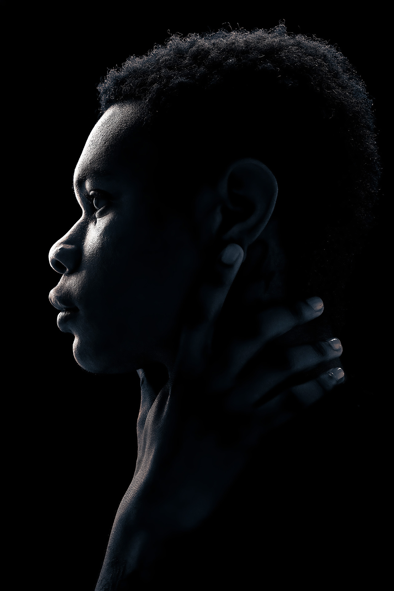 Black-and-white profile silhouette portrait with an artistic hand pose