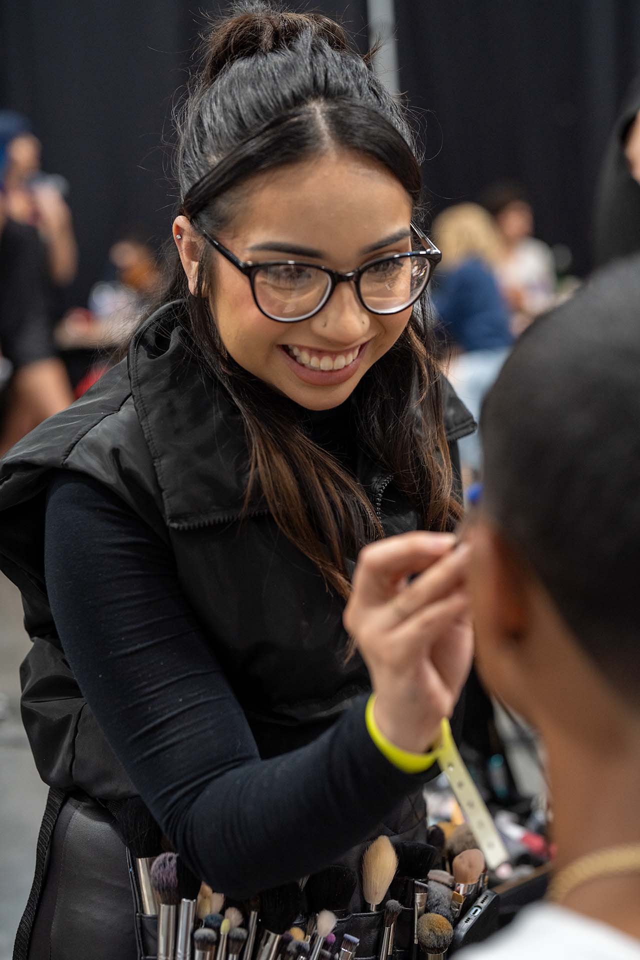 Backstage close-up of a model having makeup applied at Denver Fashion Week