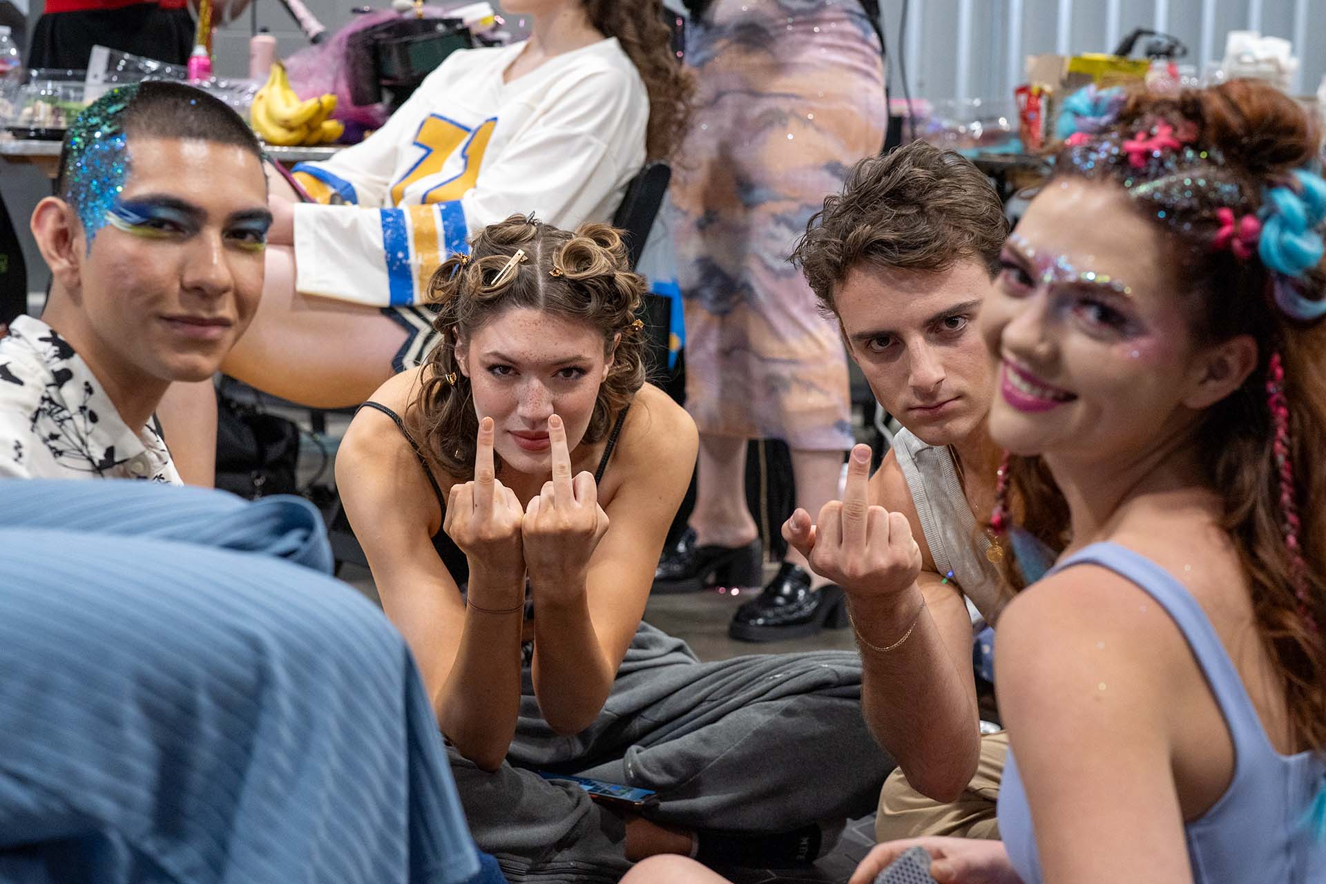 Playful group of models backstage with colorful hair, candid Denver Fashion Week photography