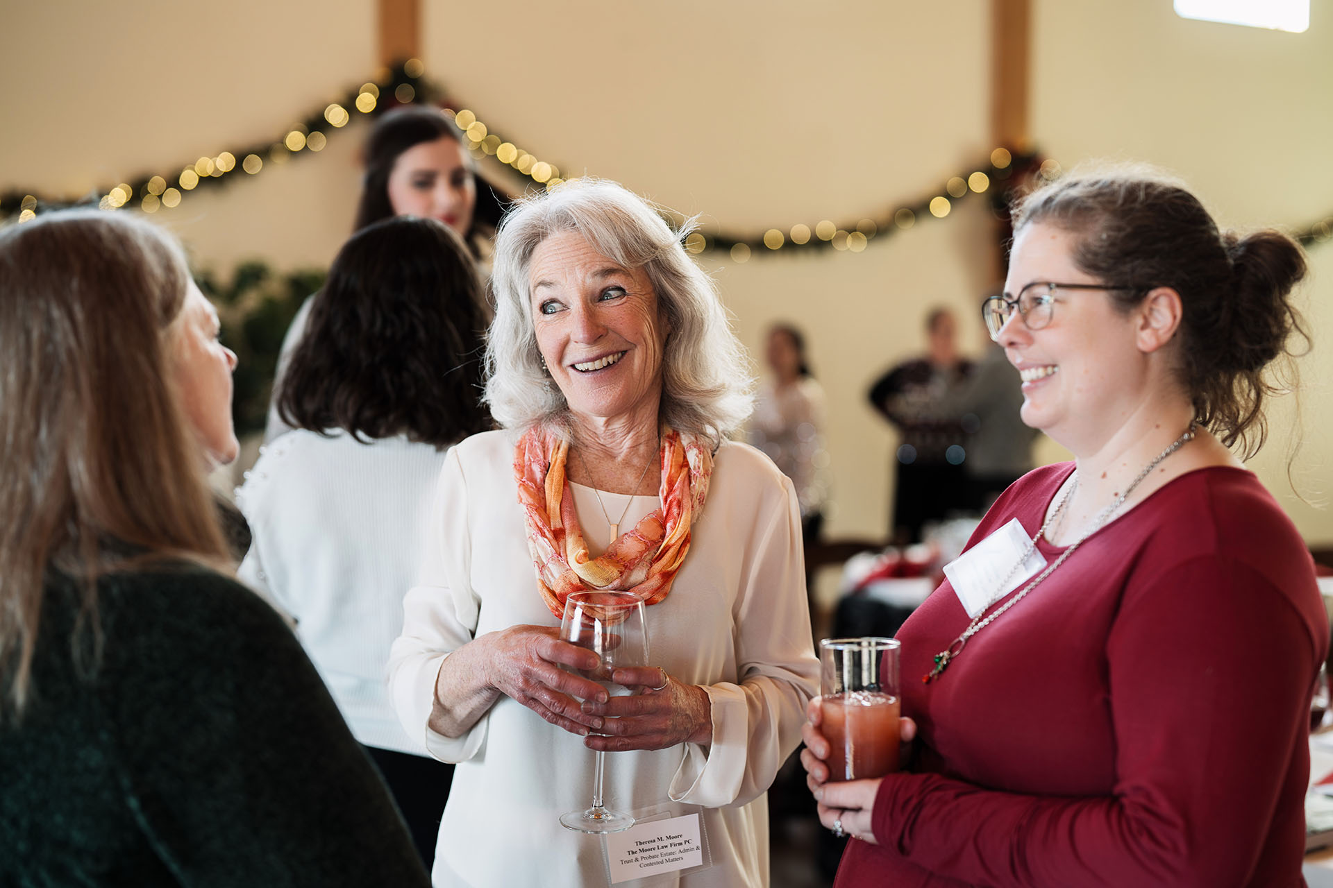 Candid group photo of women networking at an evening event
