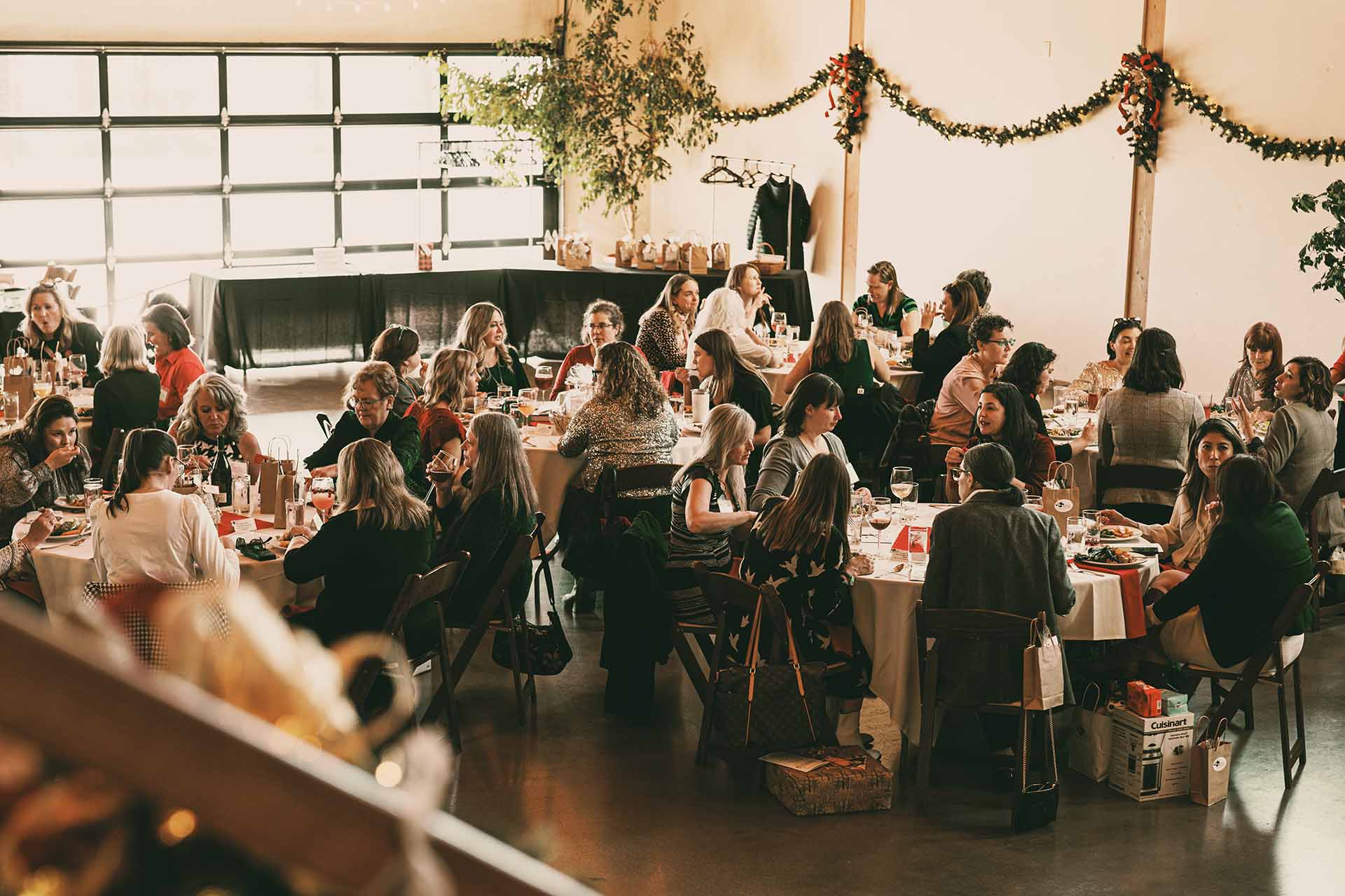 Wide shot of a gala reception with string lights and mingling guests