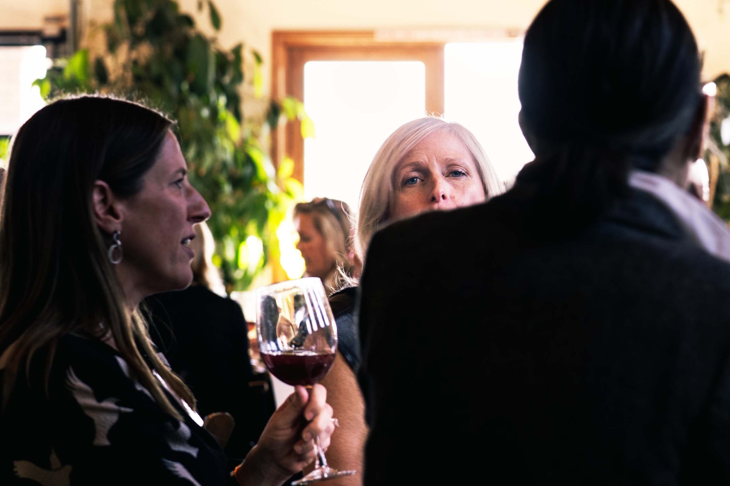 Candid photo of women talking together at an evening event