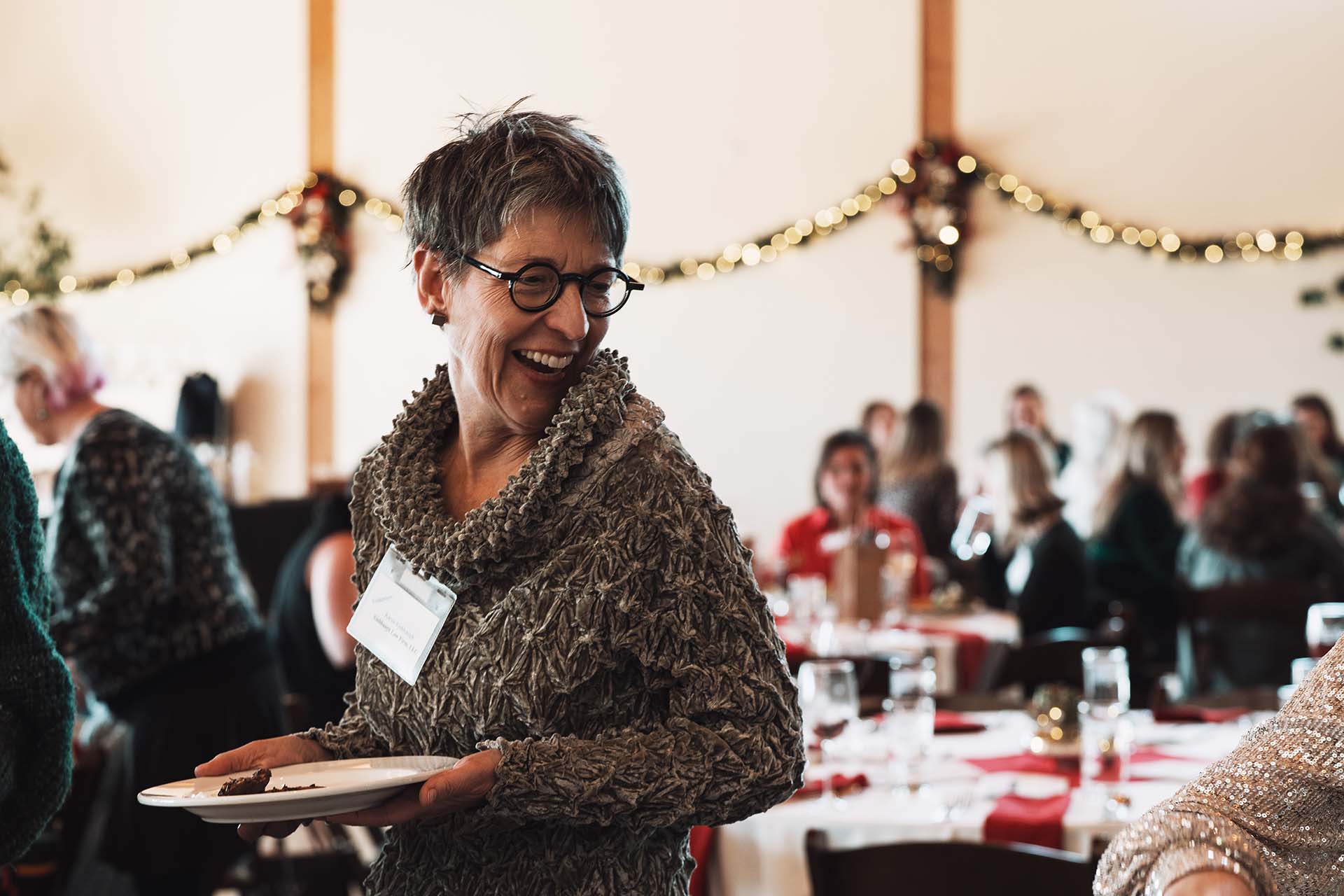 Candid photo of a woman laughing during an event dinner