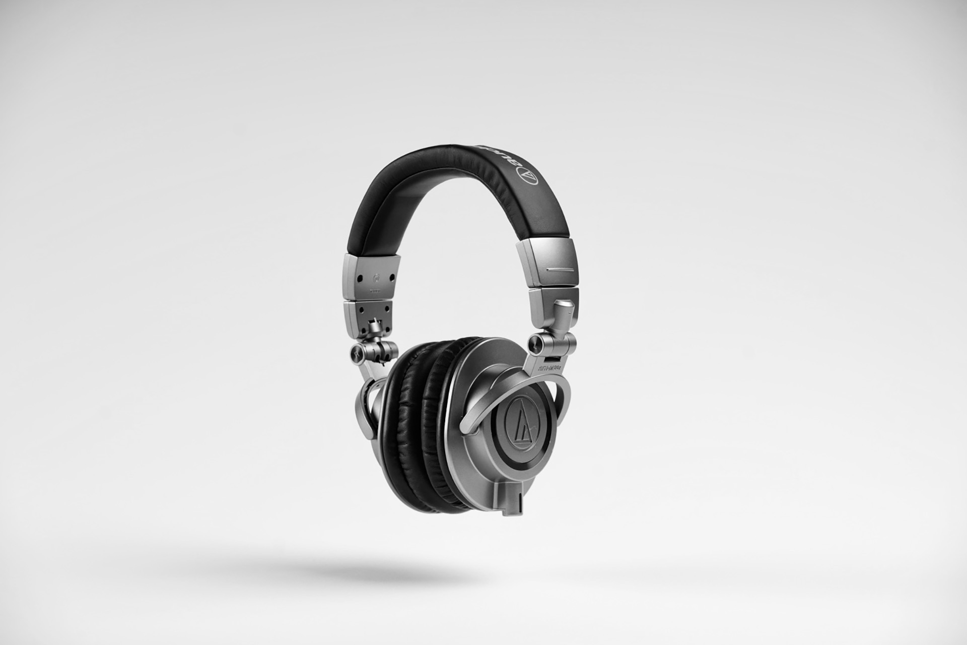 Studio product photo of black over-ear headphones on a gray background
