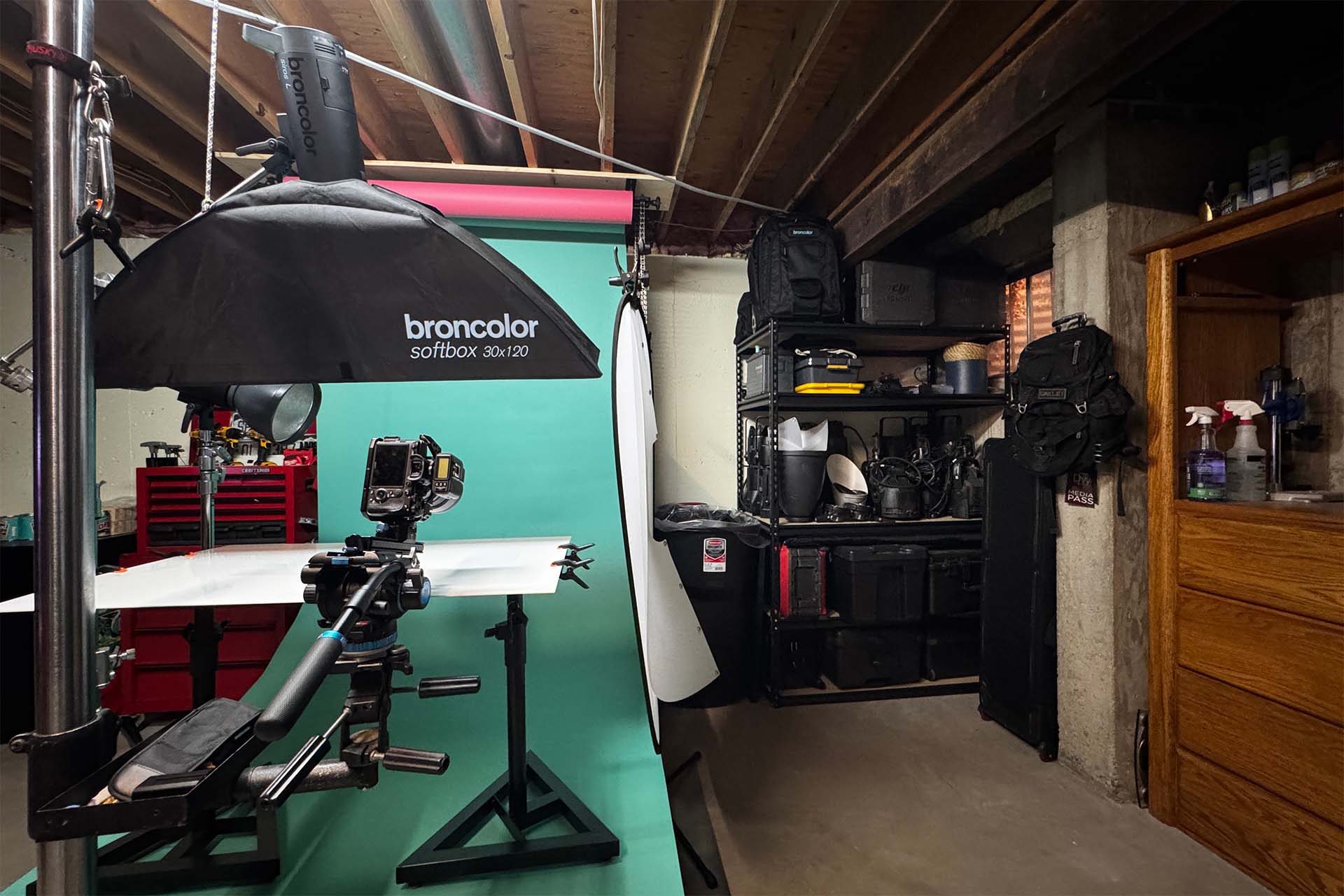Behind-the-scenes photo of a Broncolor softbox lighting setup on a teal studio backdrop