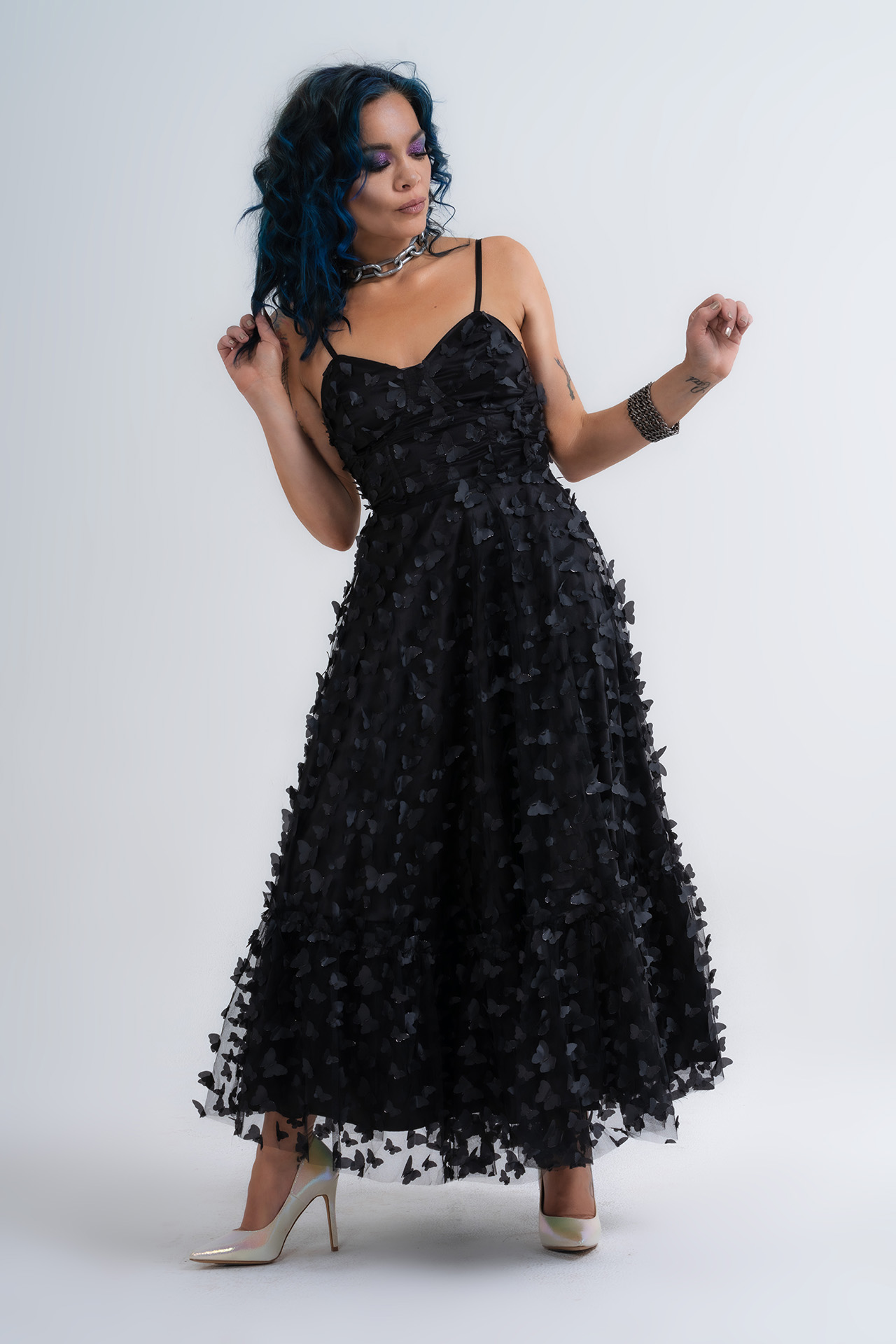 Model in a black textured tulle dress standing in a studio, Valentine's editorial fashion photography