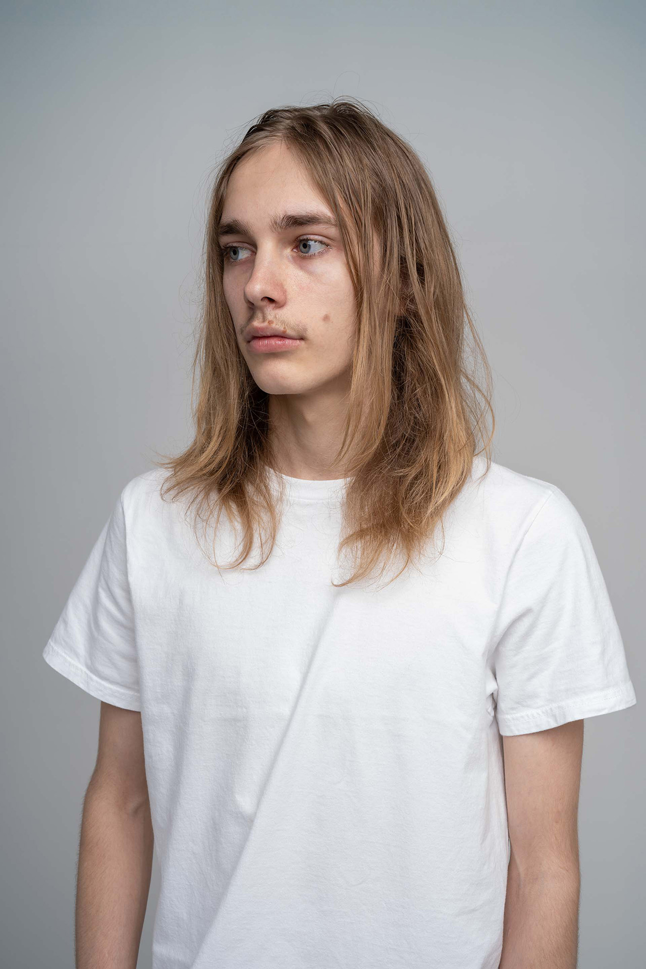 Male model portfolio digital, angled portrait, white t-shirt, neutral background
