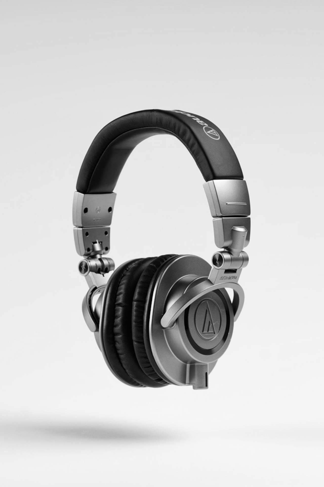 Studio product photo of black over-ear headphones on a white background