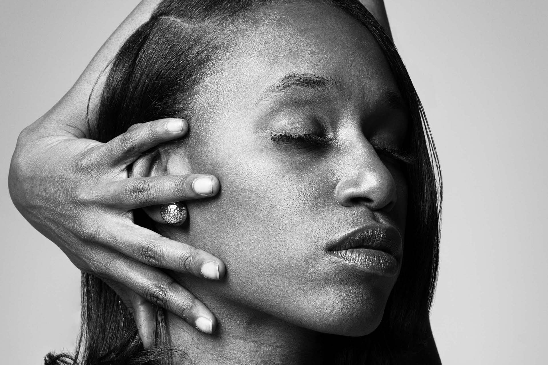 Black-and-white beauty portrait with hands gently covering part of the face, Denver fine-art photography