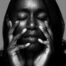 Black-and-white fine-art portrait with hands framing the face, Denver photography