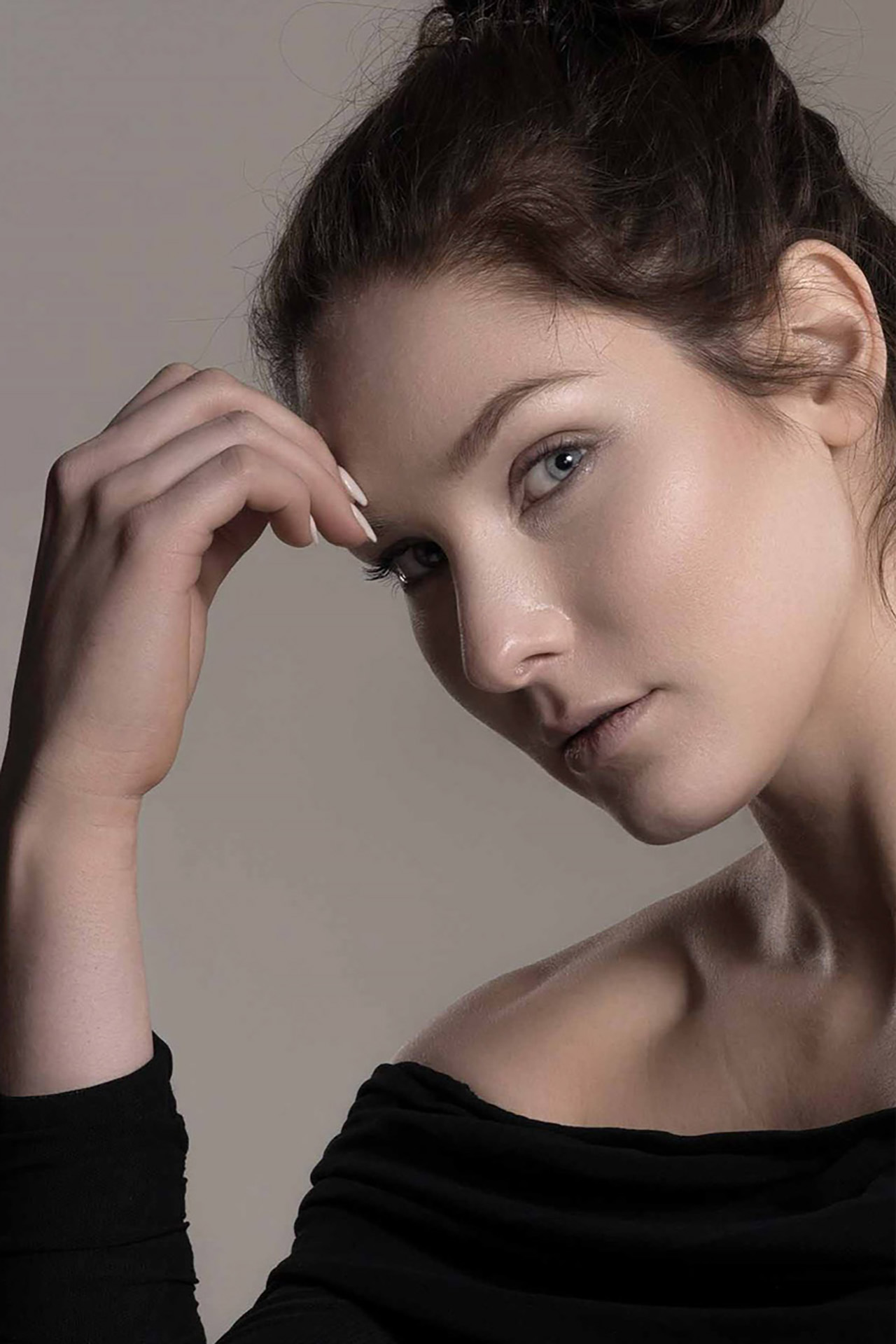 Beauty portrait of a model with her hand framing her face, soft studio lighting, Aurora & Denver photography