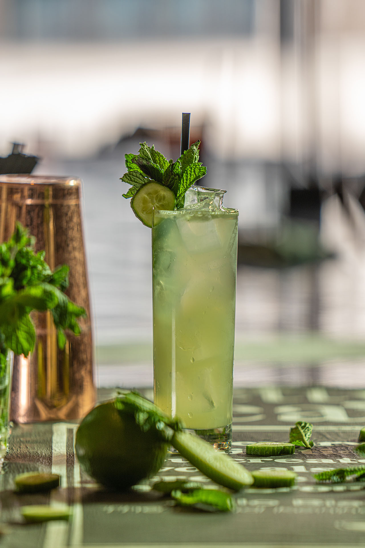 House twist on a classic mojito with mint and cucumber garnish, alternate angle, at Pretty Neat Bar